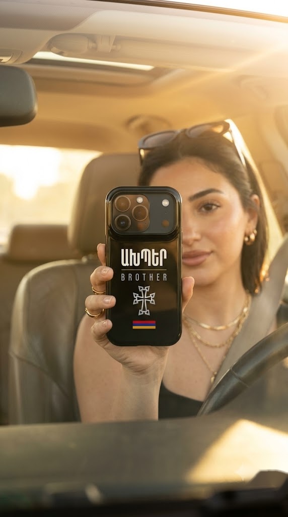 Model in a car holding the NRAN Akhper phone case